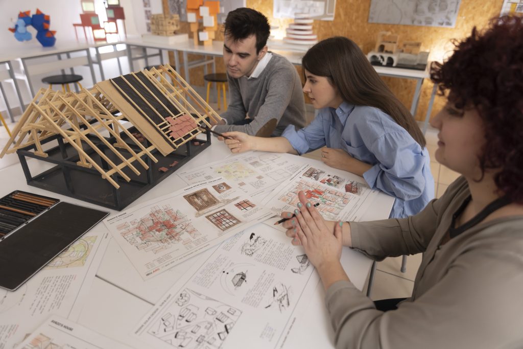 Architecture students working on a model during design class