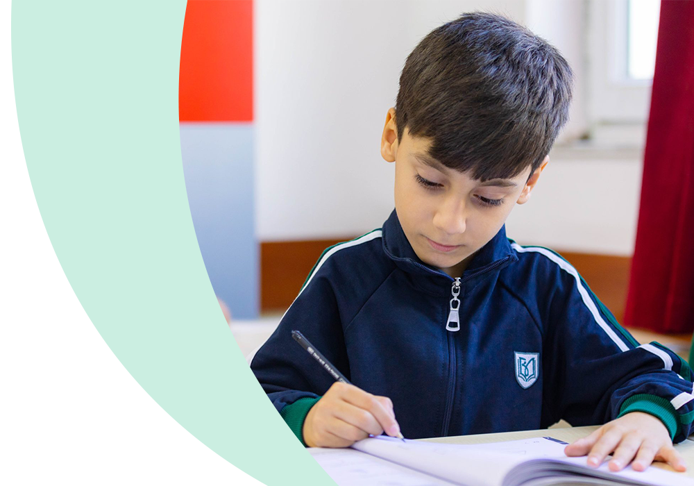 Young Stirling Education student writing in classroom